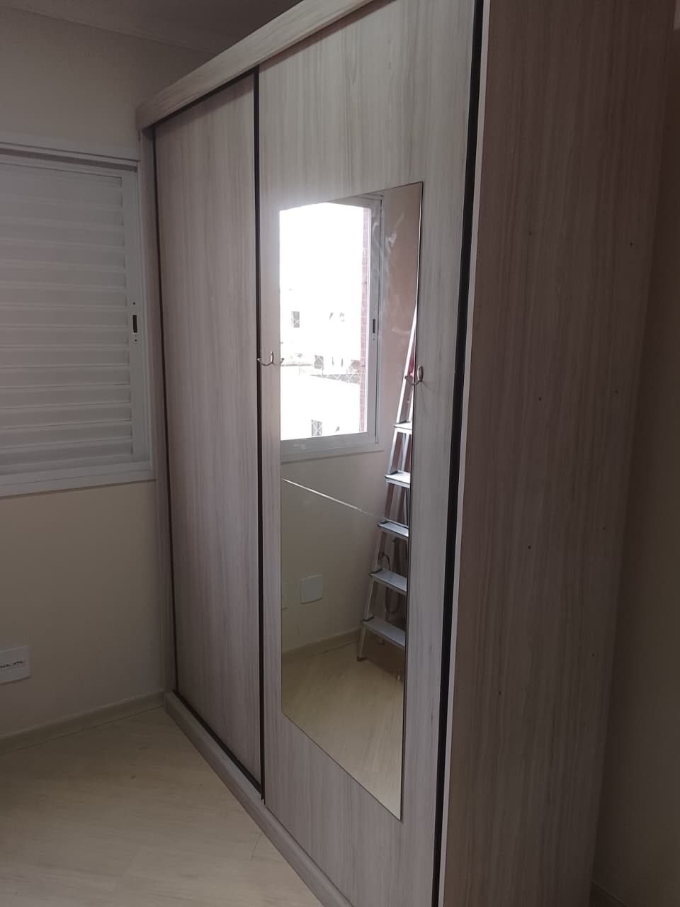 Guarda-roupa em quarto pequeno com porta espelhada
